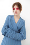 Bright red eyeshadow and nude face make up by Alice Rossi, model wearing peculiar blue coat.